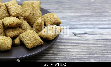 crackers on a plate on a wooden background Stock Photo