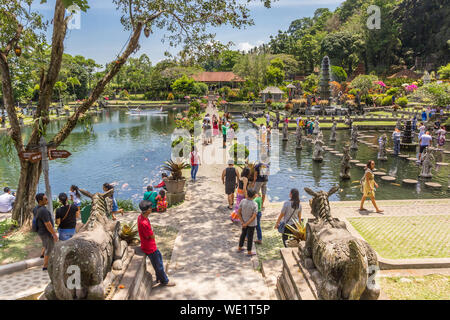 Tourists on the central footpath of Taman Tirta Gangga water palace on Bali Stock Photo