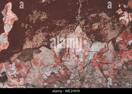 Cracked peeling paint wall texture with distressed red and white surface, grunge abstract background, weathered concrete pattern Stock Photo
