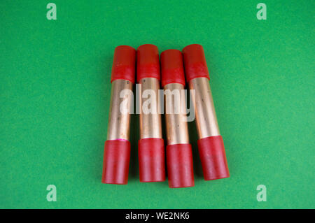Spare part of the refrigerator - filter dryer refrigerator, copper with red caps on a green background - 4 pieces. There is a place to fill the text. Stock Photo