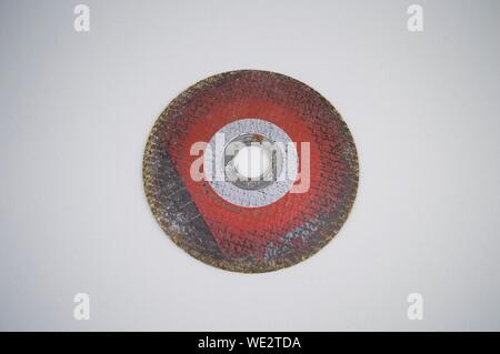 Grinding disc on a gray background with empty space for text. Stock Photo