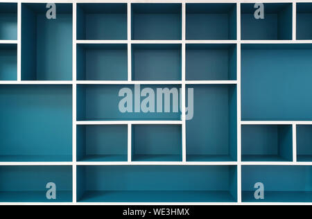 Empty closet shelves background. Modern wooden wardrobe boxes, beautiful blue and white frame interior design combination, abstract shape and patterns Stock Photo