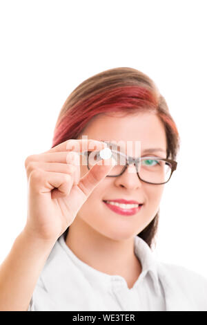 Close up shot of a smiling young doctor holding a pill, isolated on white background. Take from these one per day and come in a week from now. Stock Photo