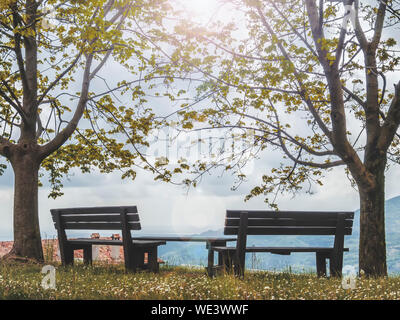 Beautiful bench at the countryside. Rest place with a view high in the mountains. Stock Photo