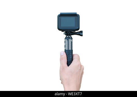 Action camera on stick in hand isolated in white. Blank screen for mockup. Stock Photo