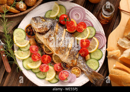 Roast Dorada on a wooden background Stock Photo