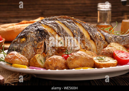 Roast Dorada on a wooden background Stock Photo
