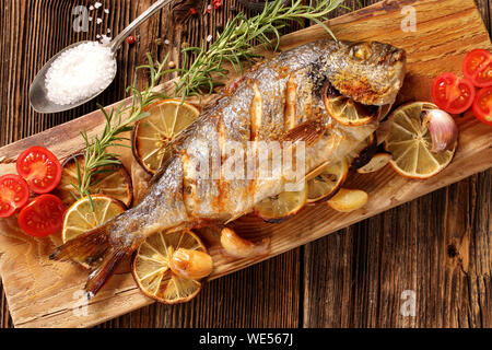 Roast Dorada on a wooden background Stock Photo