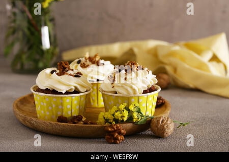 cream cupcakes with walnuts for dessert Stock Photo