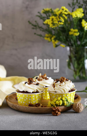 cream cupcakes with walnuts for dessert Stock Photo
