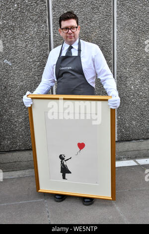 London, UK. 30th Aug, 2019. Anonymous street artist Banksy's iconic work Girl With Balloon goes on display near one of the original locations the artwork appeared at, National Theatre, South Bank in London, ahead of a ‘Banksy: I can't believe you Morons actually buy this sh*t' online-only auction of the artist's work, at at Christies.com. Banksy, Girl with Balloon, 2004, Estimate: £50,000-70,000 London, UK - 30 August 2019 Credit: Nils Jorgensen/Alamy Live News Stock Photo