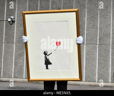 London, UK. 30th Aug, 2019. Anonymous street artist Banksy's iconic work Girl With Balloon goes on display near one of the original locations the artwork appeared at, National Theatre, South Bank in London, ahead of a ‘Banksy: I can't believe you Morons actually buy this sh*t' online-only auction of the artist's work, at at Christies.com. Banksy, Girl with Balloon, 2004, Estimate: £50,000-70,000 London, UK - 30 August 2019 Credit: Nils Jorgensen/Alamy Live News Stock Photo