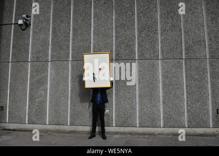 London, UK. 30th Aug, 2019. Anonymous street artist Banksy's iconic work Girl With Balloon goes on display near one of the original locations the artwork appeared at, National Theatre, South Bank in London, ahead of a ÔBanksy: I can't believe you Morons actually buy this sh*tÕ online-only auction of the artist's work, at at Christies.com. Banksy, Girl with Balloon, 2004, Estimate: £50,000-70,000 London, UK - 30 August 2019 Credit: Nils Jorgensen/Alamy Live News Stock Photo