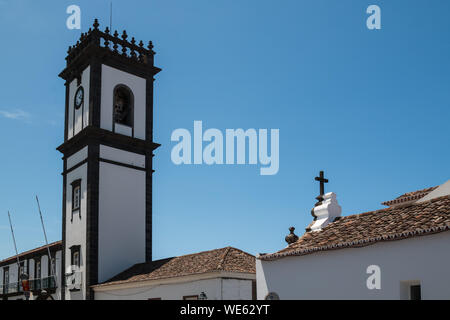 Characteristic tower of the City hall, with white facade and square shape. Belfry in the upper part. Blue sky. Ribeira Grande, Sao Miguel, Azores Isla Stock Photo