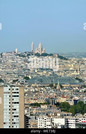 France, Paris, Basilique du Sacre Coeur (Sacred Heart Basilica) on the Butte Montmartre and view of the glass roof of the Grand Palais Museum Stock Photo