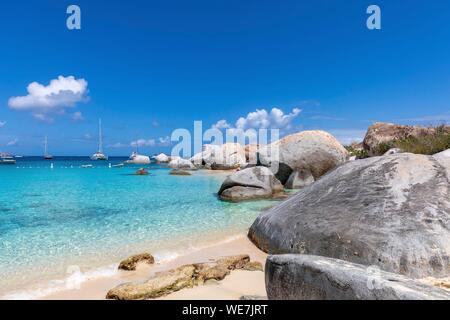 West Indies, British Virgin Islands, Virgin Gorda Island, The Baths, view of the baths beach, sailboats anchored, deserted beach in the foreground the typical rocks of the island Stock Photo