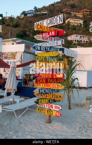 West Indies, British Virgin Islands, Tortola Island on the beach of Cane Garden Bay a signpost of different destinations in the world Stock Photo