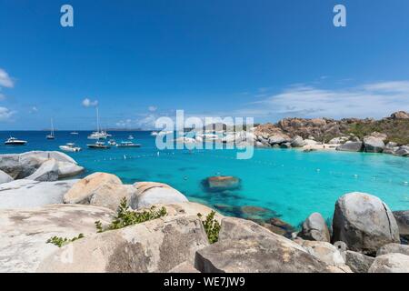 West Indies, British Virgin Islands, Virgin Gorda Island, The Baths, bathing beach view, sailboats at anchor, in the foreground the typical rocks that surround the paradisiacal swimming area Stock Photo