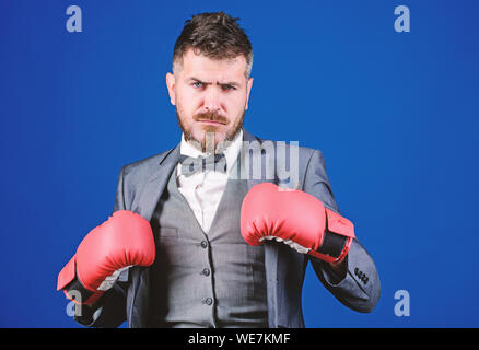 Inspired to work hard. knockout and energy. Fight. bearded man in boxing gloves punching. powerful man boxer ready for corporate battle. businessman in formal suit and tie. Business and sport success. Stock Photo