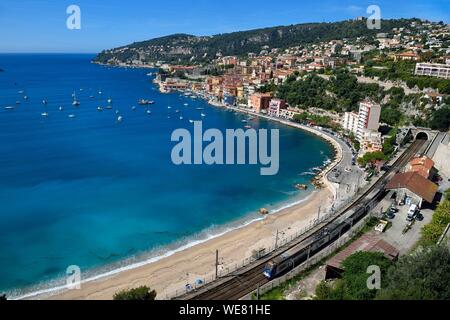 France, Alpes Maritimes, Villefranche sur Mer, the beach in the bay and the train station Stock Photo
