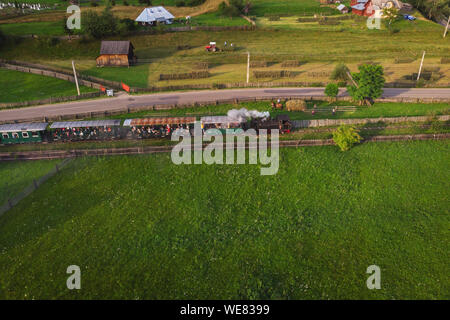 Aerial summer view of steam train in Bucovina. Mocanita Hutulca touristic train from Moldovita Stock Photo