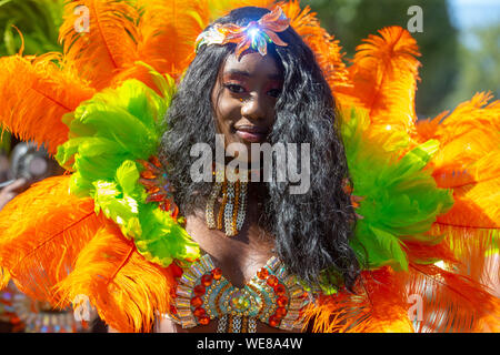 Colourful costumes at the Notting Hill Carnival which celebrates Caribbean culture. It attracts over 2 million people every year. Stock Photo