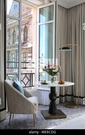 France, Paris, Hotel du Louvre, homemade pastries on a table in a hotel suite in front of a window open to the Louvre Museum and the Place du Palais Royal