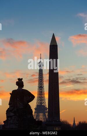 France, Paris, area listed as World Heritage by UNESCO, Place de la Concorde, a statue representing one of the main cities of France, the Eiffel Tower and the Obelisk at sunset