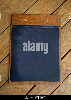 Blackboard on wooden surface with copy space Stock Photo