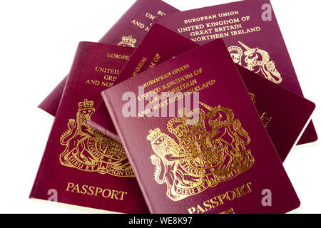 A stack of old and new UK passports isolated on a white background Stock Photo