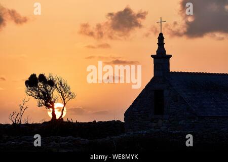 France, Finistere, Iroise Sea, Iles du Ponant, Parc Naturel Regional d'Armorique (Armorica Regional Natural Park), Ile de Sein, labelled Les Plus Beaux de France (The Most Beautiful Village of France), the Saint Corentin Chapel at sunset Stock Photo