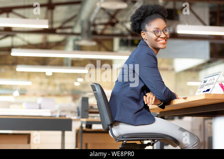 Cheerful interior designer smiling after finishing work Stock Photo