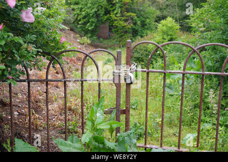 Old padlocked rusty gates Stock Photo