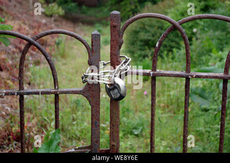 Old padlocked rusty gates Stock Photo