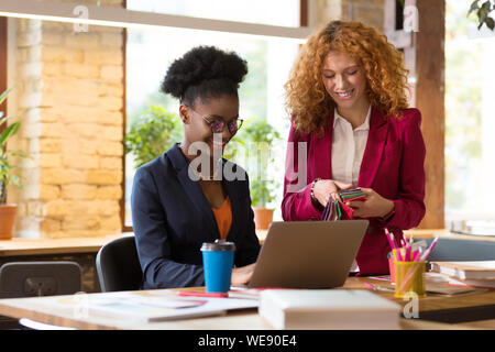 Interior designer smiling while working together on one project Stock Photo