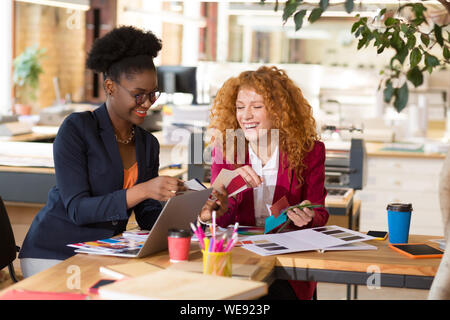 Interior designers laughing while working together in the office Stock Photo