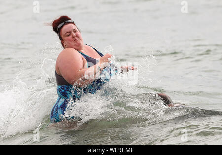 Bournemouth Dorset 30th August 2019. UK weather: Beachgoers on Bournemouth Beach brave a windy start to the day. Credit Stuart Martin/ Alamy Live News Stock Photo