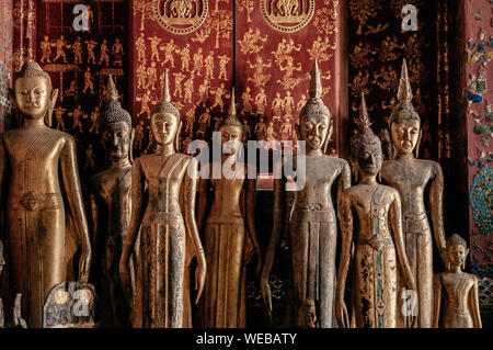 APR 5 Luang Prabang, Laos - Antique old wooden and gold Buddha statues at Wat  Xieng thong museum.  Most Famous tourist attraction in World heritage z Stock Photo