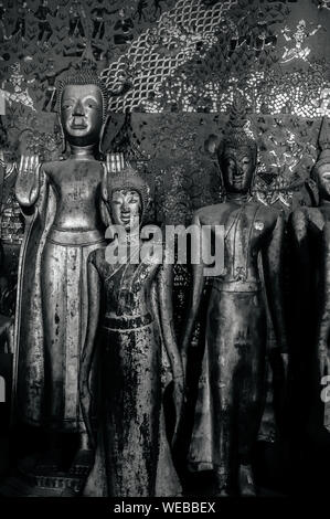 APR 5 Luang Prabang, Laos - Antique old wooden Buddha statues at Wat  Xieng thong museum.  Most Famous tourist attraction in World heritage zone Stock Photo