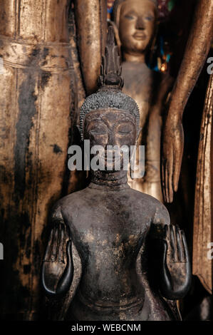 APR 5 Luang Prabang, Laos - Antique old wooden and gold Buddha statues at Wat  Xieng thong museum.  Most Famous tourist attraction in World heritage z Stock Photo
