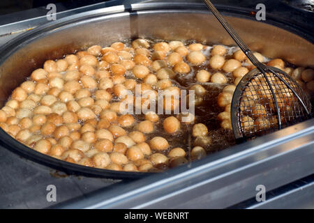 Turkish lokma dessert - Lokma is a Turkish fried sweet dough covered in a syrup and served. Stock Photo