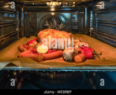 appetizing roast turkey with vegetables in the oven. Stock Photo
