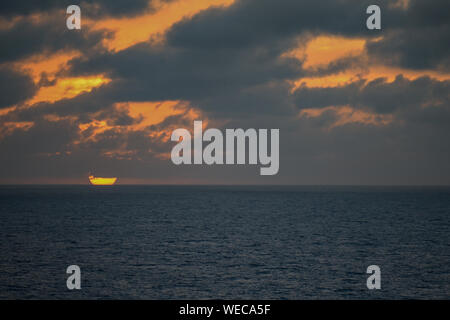 Dramatic sunset with clouds and sun rays over Caribbean sea - colorful sunset light rays - clouds and sun rays | sun rays - Caribbean Sunset Stock Photo