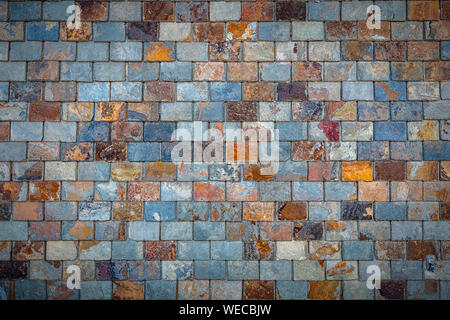 A grungy background texture of stone slate tiles. Stock Photo