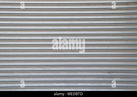 Rolling steel door background. Steel rolling door surface. Stock Photo