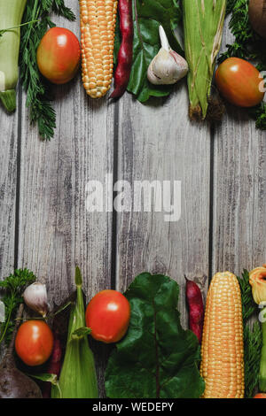Healthy food clean eating selection. Corn, tomatoes, zucchini, carrot, beetroot, garlic, bean on wooden background. Food concept. Flat lay, top view. Stock Photo