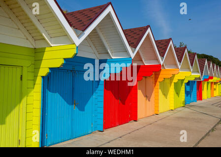 Multi-coloured beach huts along the promenade at North Bay, Scarborough, North Yorkshire, UK Stock Photo