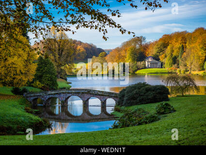 The landscape garden of Stourhead Wiltshire UK in late autumn looking over the lake to the Pantheon temple in the distance Stock Photo