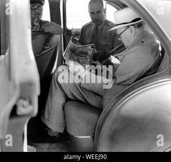 Churchill at the Washington Conference with Pres. Roosevelt.  Here studying a photograph with Gen.Doolittlel of Allied bomb damage in Italy. 24/5/43 Stock Photo