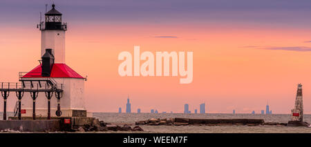 Lighthouse in Washington Park in Michigan City, Indiana during the golden hour with Chicago in the Background. Stock Photo